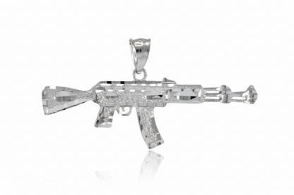 Silver gun-shaped pendant on a white background