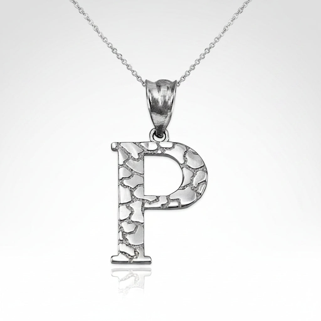 A silver initial pendant necklace featuring the letter 'P' with a textured, crackled metallic finish, suspended from a delicate silver chain on a white background.