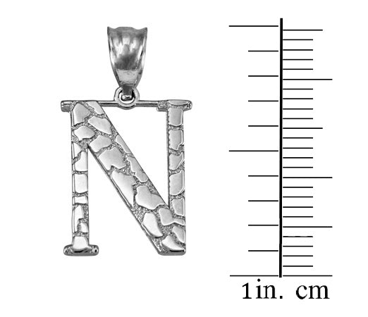 Silver letter 'N' initial pendant with a textured, cracked stone pattern, shown next to a 1-inch centimeter scale on a white background.
