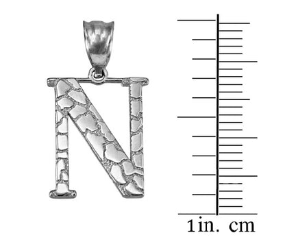 Silver letter 'N' initial pendant with a textured, cracked stone pattern, shown next to a 1-inch centimeter scale on a white background.