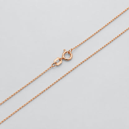 Rose gold chain necklace on a white background