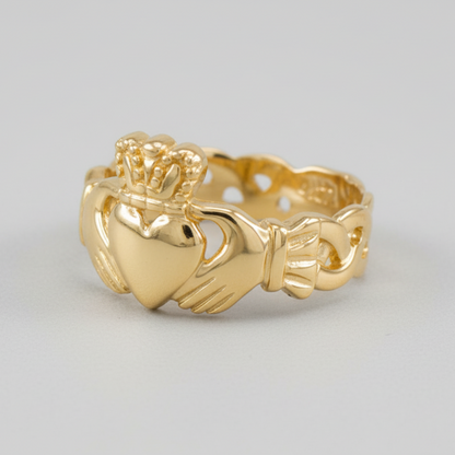 Gold Claddagh ring on a light gray background