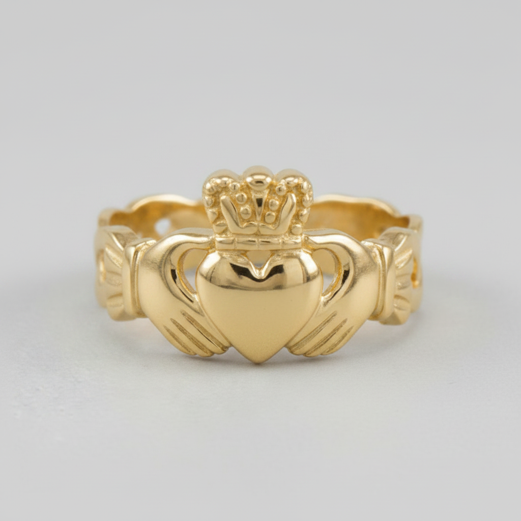 Gold Claddagh ring on a light gray background