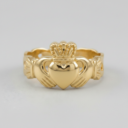 Gold Claddagh ring on a light gray background