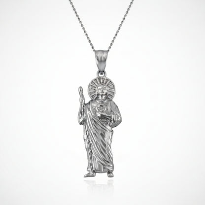 Silver pendant of a religious figure on a white background