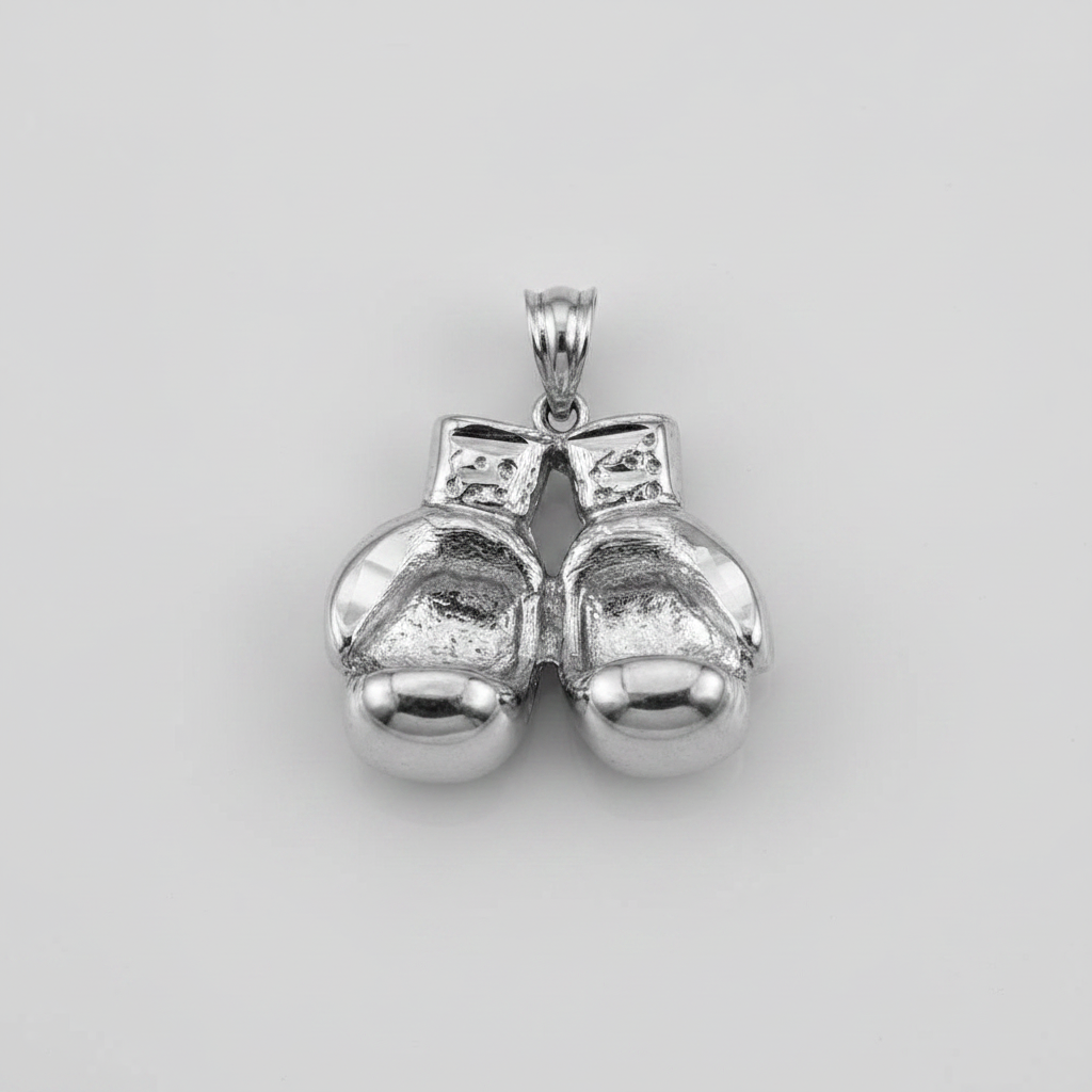 A polished silver pendant shaped like a pair of boxing gloves tied together with a bow, shown on a neutral light gray background.