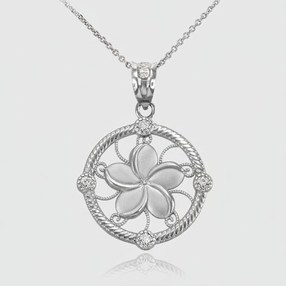 A silver-tone plumeria flower pendant necklace on a delicate chain, set against a clean white background with a subtle reflection below.