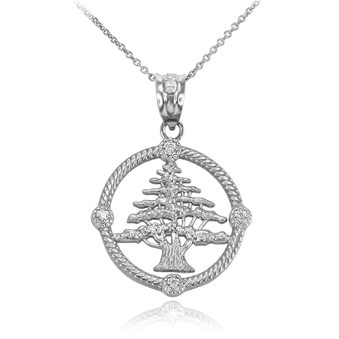 A sterling silver pendant necklace featuring a detailed cedar tree design enclosed in a circular frame with rope-textured edges and small clear stones, suspended from a delicate chain on a white background.