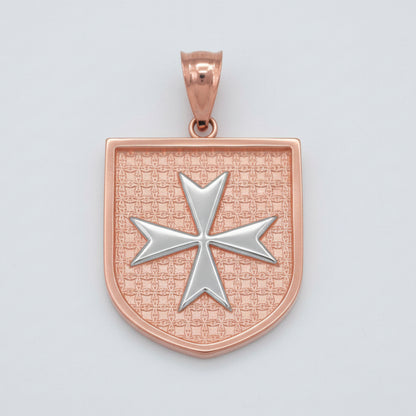 Rose gold pendant with a silver cross on a light gray background