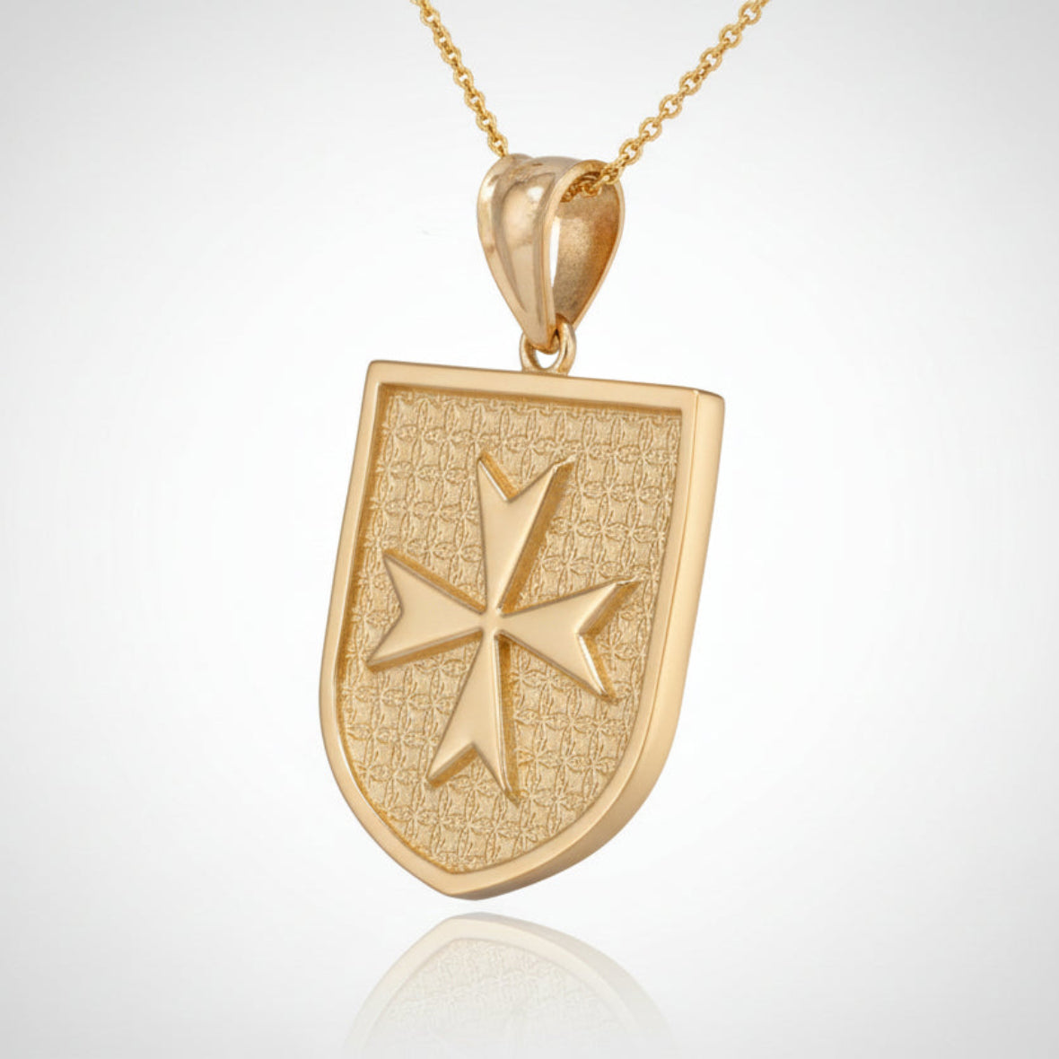 Gold pendant with a shield design and star emblem on a white background