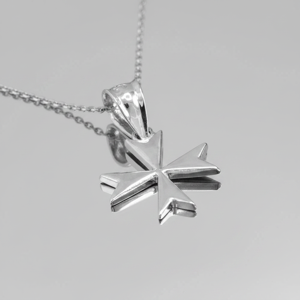 Silver star-shaped pendant on a chain against a gray background