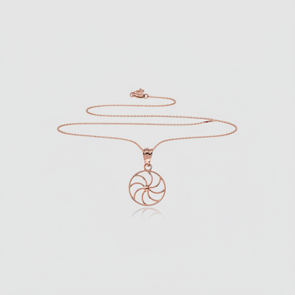 Rose gold circular pendant necklace on a white background