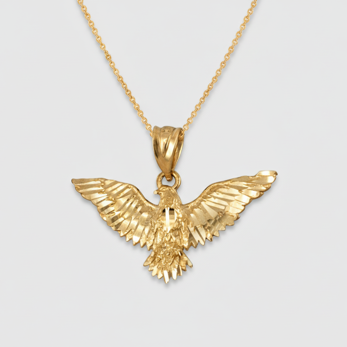 Gold eagle pendant on a gold chain necklace