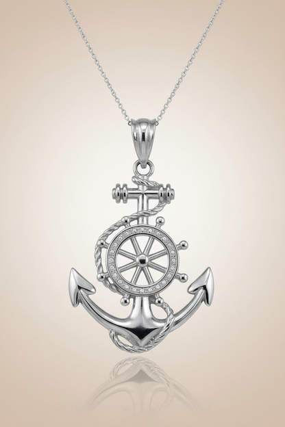 Silver anchor and wheel pendant on a beige background