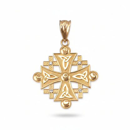 A gold jerusalem cross pendant featuring intricate knotwork and triquetra designs, accented with small clear stones, shown on a plain white background.