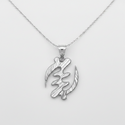 A silver pendant necklace featuring a stylized, abstract calligraphic design with textured striations and a beaded border, suspended from a delicate silver chain against a light gray background.