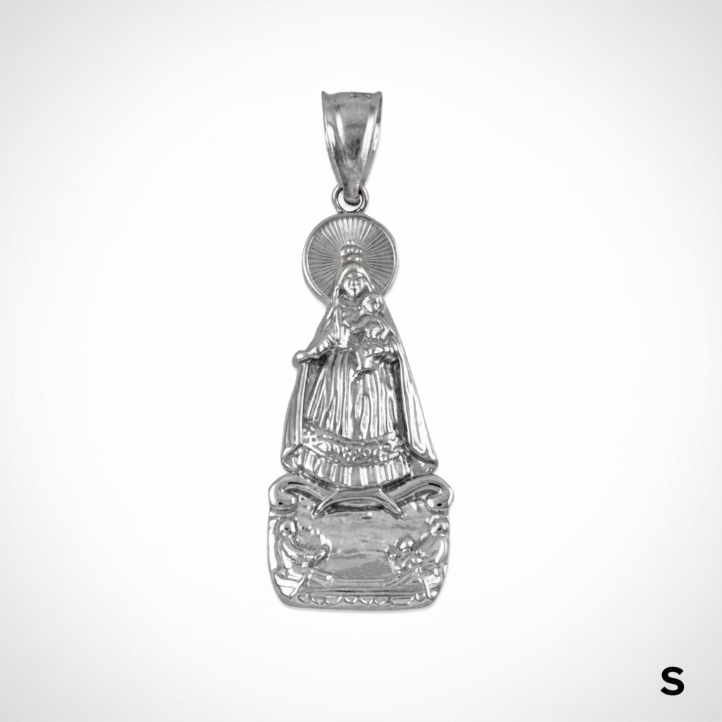 Silver pendant with intricate design on a white background with measurement scale.