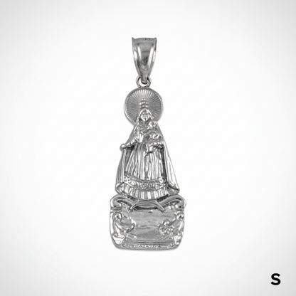 Silver pendant with intricate design on a white background with measurement scale.