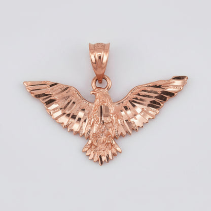 Rose gold eagle pendant on a white background