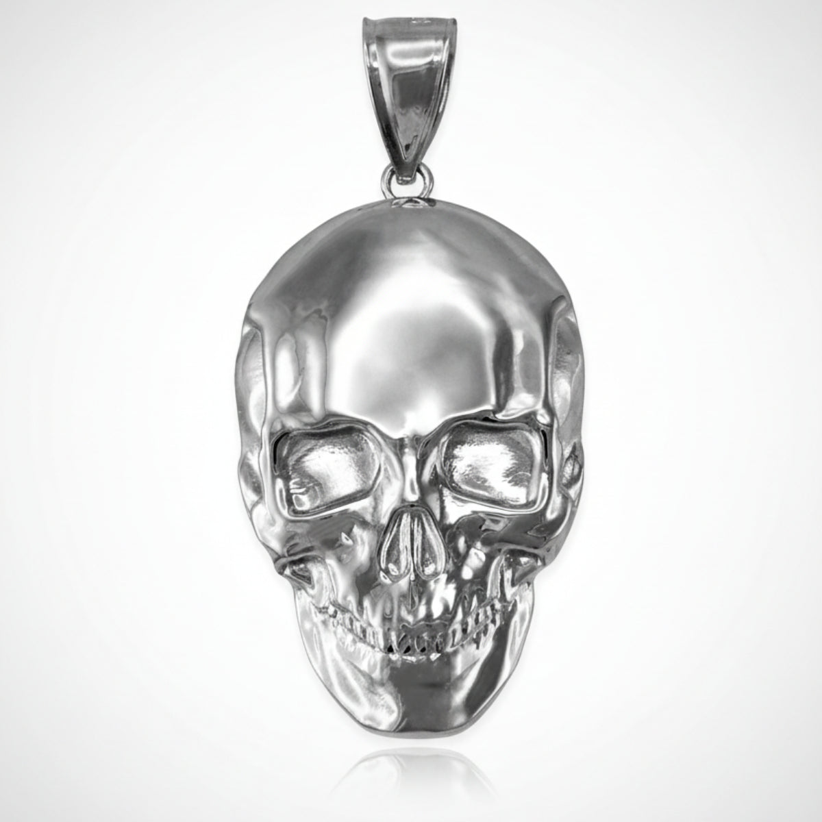 Silver skull pendant on a white background