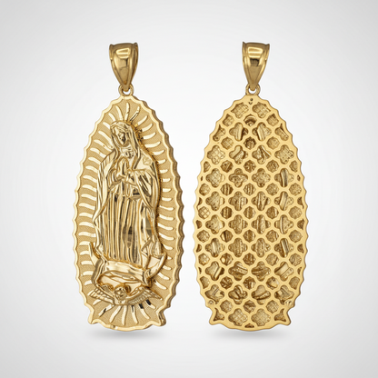 Gold pendant with religious design next to a U.S. dime for scale on a white background