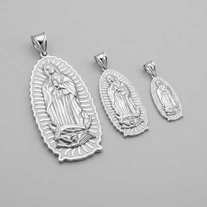 Set of three silver religious pendants on a gray background
