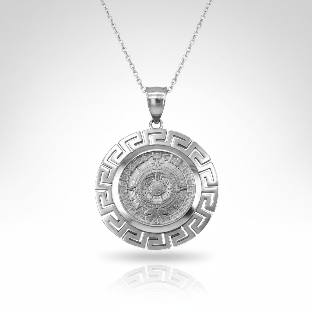 A silver pendant necklace featuring a circular Greek key border and a detailed central compass design, suspended from a fine silver chain against a light gray gradient background.
