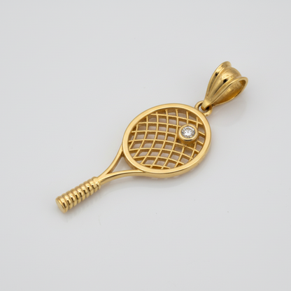 Gold tennis racket pendant with a diamond on a light gray background