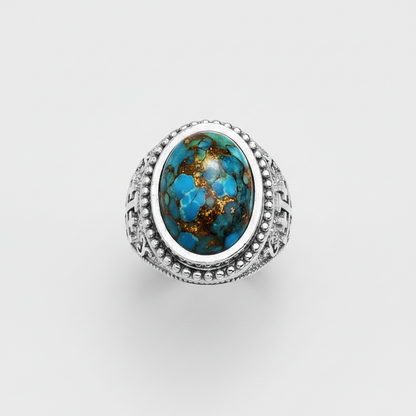 A sterling silver ring featuring a large oval turquoise cabochon with natural brown matrix veining, set in a wide band with decorative textured silver sides.