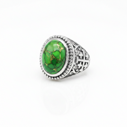 A silver-toned signet ring featuring an oval green stone with natural gold veining, set against a clean white background.