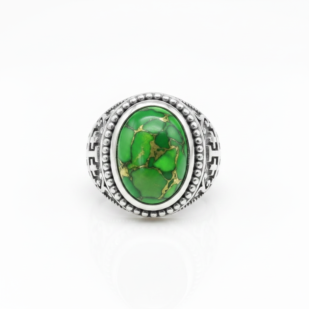 A silver-toned ring featuring an oval green stone with natural gold and darker green veining, set in a detailed textured bezel on a white background.