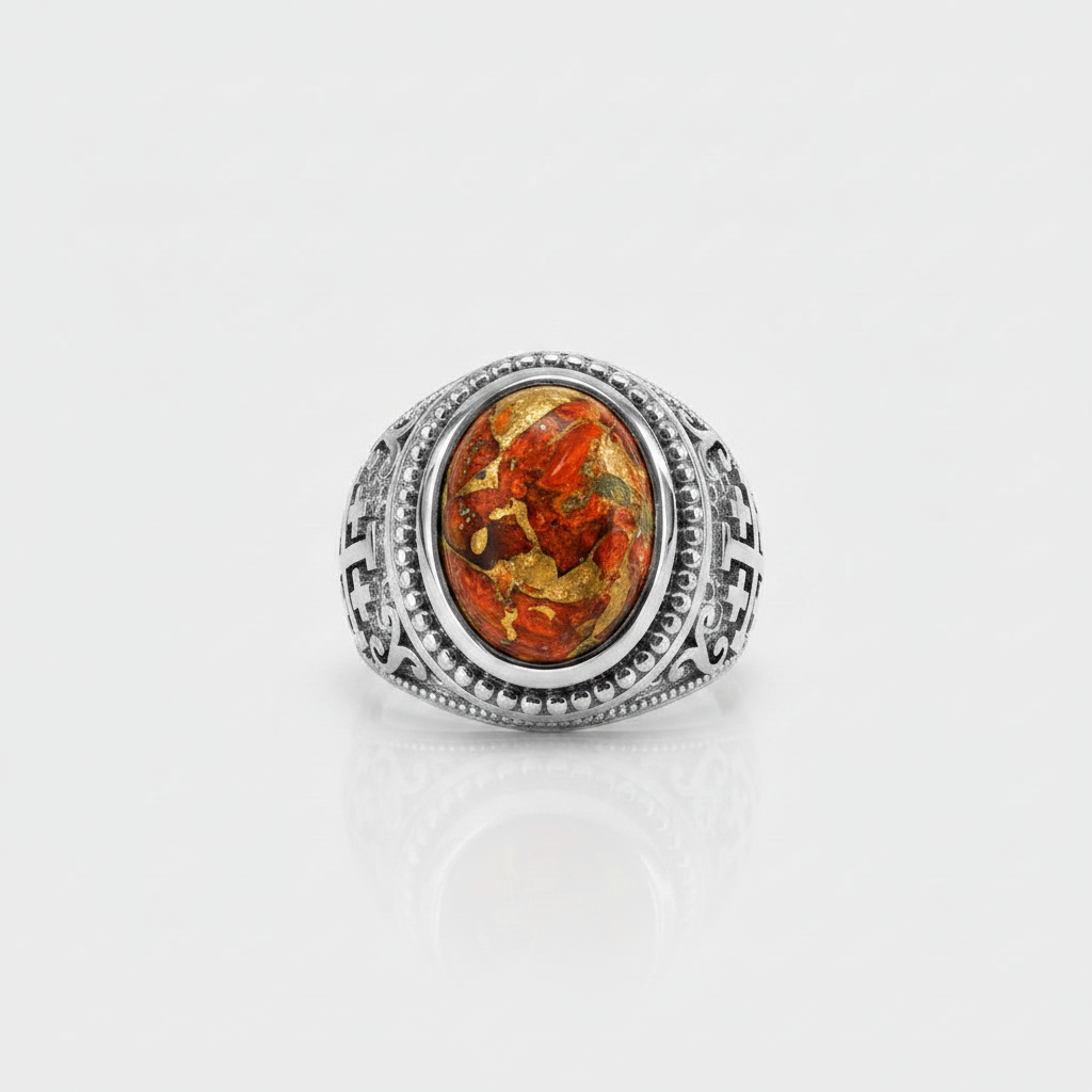 A silver-toned ring featuring an oval amber cabochon with visible golden and orange inclusions, set against a clean white background with a soft reflection below.