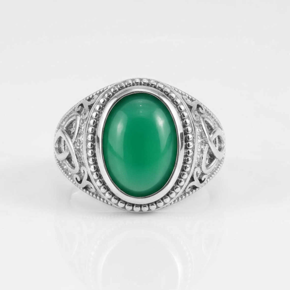 Silver ring with a green gemstone on a white background
