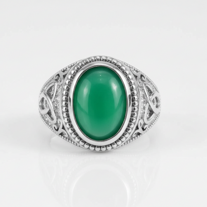 Silver ring with a green gemstone on a white background