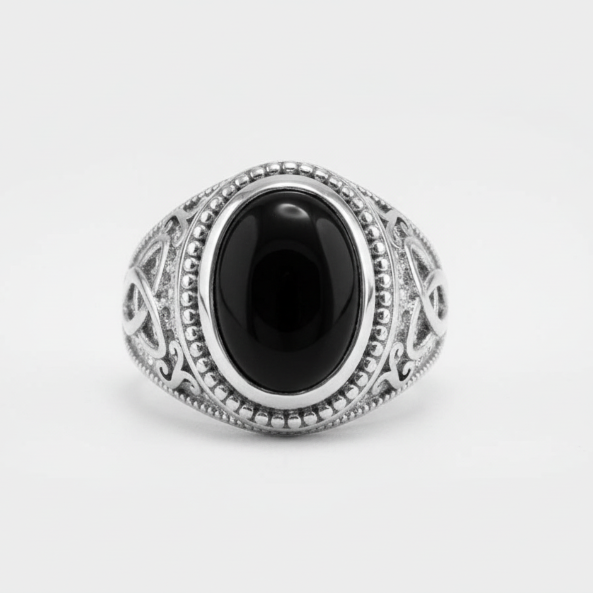 Silver ring with a black stone on a white background