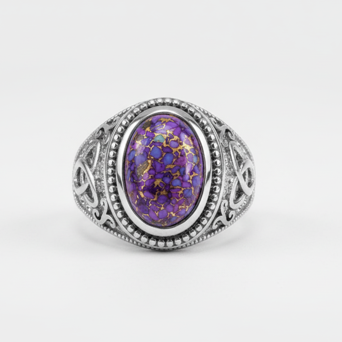 Silver ring with a purple gemstone on a white background