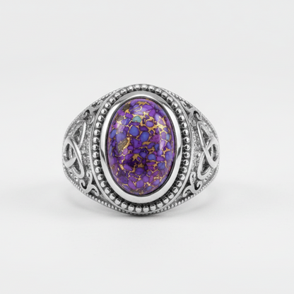 Silver ring with a purple gemstone on a white background
