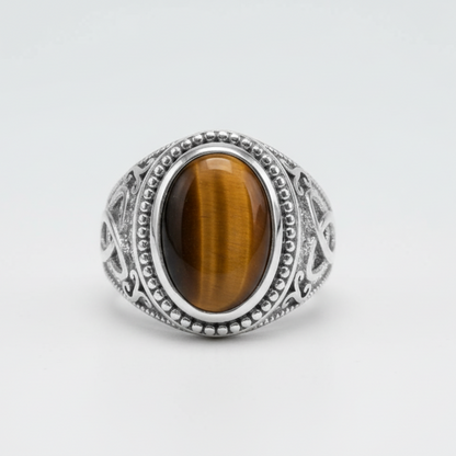 Silver ring with a brown gemstone on a white background