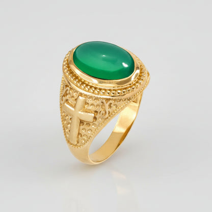 Gold ring with a green gemstone on a white background