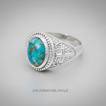 Silver ring with turquoise stone on a gray background