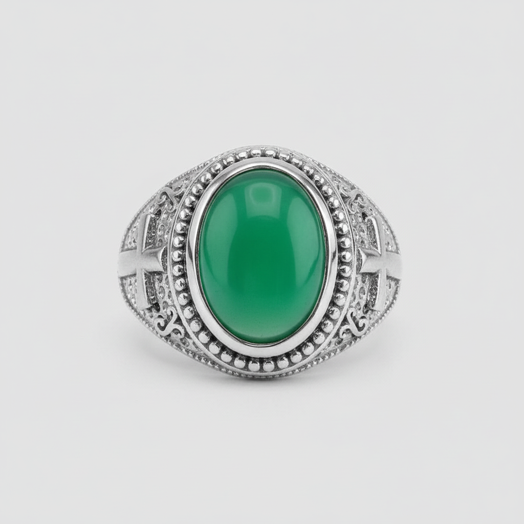 Silver ring with a green gemstone on a light gray background
