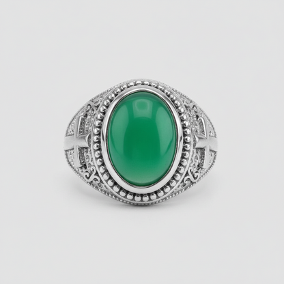 Silver ring with a green gemstone on a light gray background