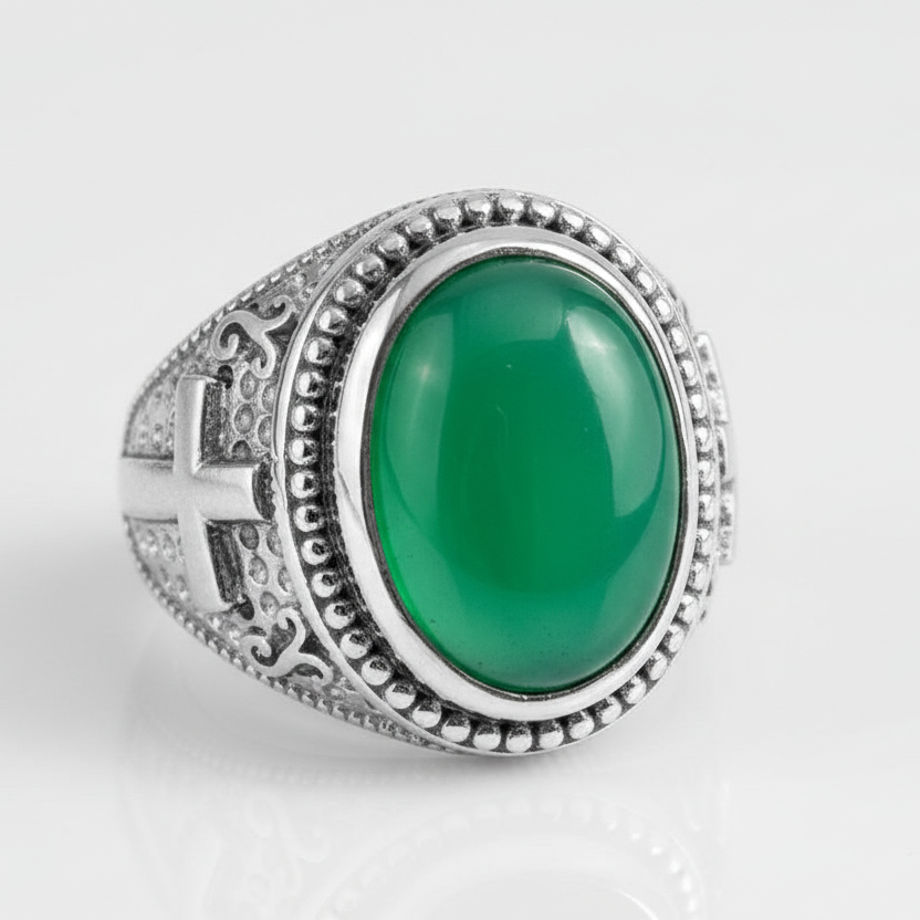 Silver ring with a green stone on a white background