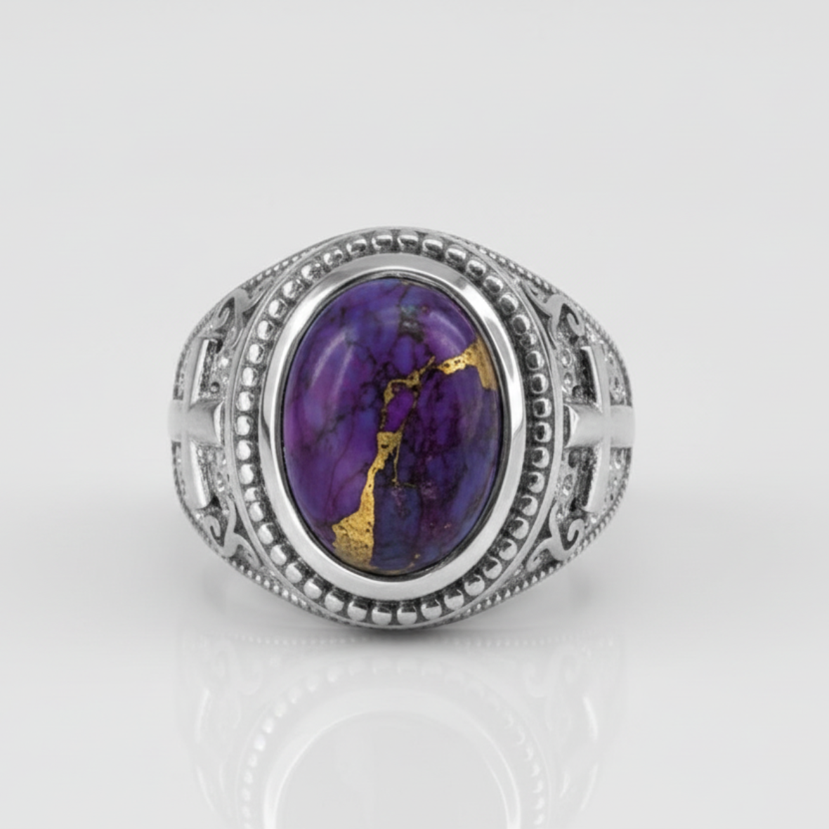 Silver ring with a purple gemstone on a white background