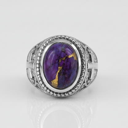Silver ring with a purple gemstone on a white background