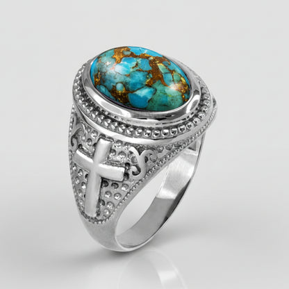 Silver ring with turquoise stone and cross design on a light gray background