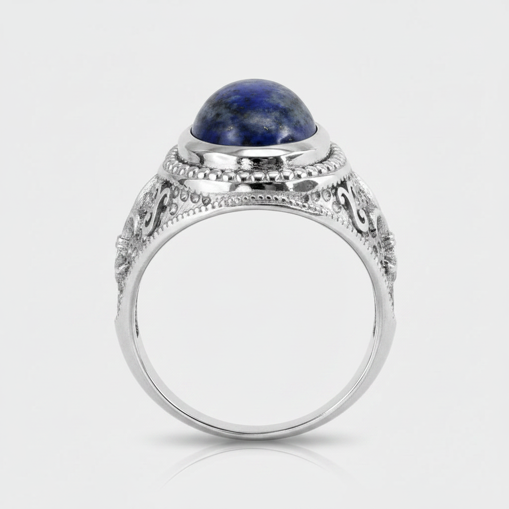 A silver-toned ring with an oval dark blue lapis lazuli stone set in an ornate filigree band, shown on a light gray background.