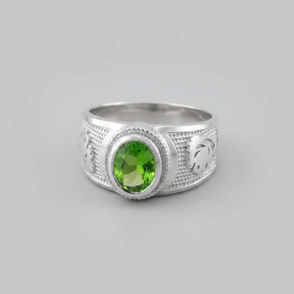 Silver ring with a green gemstone on a gray background