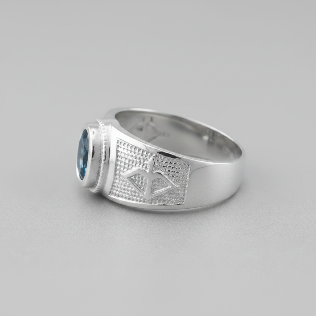 Silver ring with blue gemstone on a gray background
