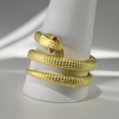 Textured yellow gold coiled snake wrap ring with ruby eyes, available in 10K & 14K.